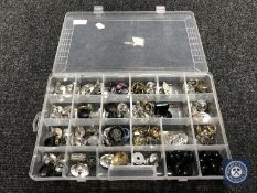 A plastic storage box containing approximately 100 costume rings