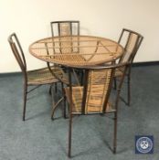 A circular metal folding patio table and four chairs