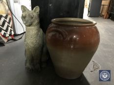 A concrete cat garden figure and a glazed pot