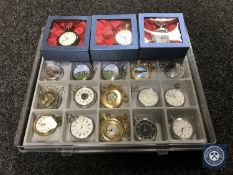 A display case containing twenty modern pocket watches together with a further three boxed pocket