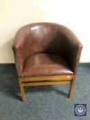 A faux leather upholstered tub chair