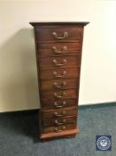 A narrow Eastern mahogany ten drawer chest