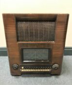 An HMV wireless radio in a walnut case.