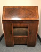 An early 20th century HMV radio turn table bureau, with integrated speaker and storage.