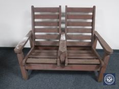 A teak twin chair reclining bench