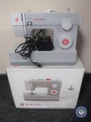 A boxed Singer heavy duty 4411 electric sewing machine