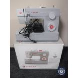 A boxed Singer heavy duty 4411 electric sewing machine