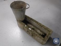 A stone plant trough and a galvanized bucket