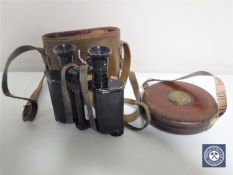 A pair of leather cased Chevalier binoculars together with a vintage leather cased tape measure by