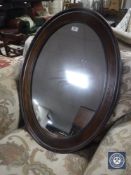 An early 20th century mahogany framed oval mirror