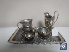 An embossed silver tray, a silver cream jug, embossed silver mug,