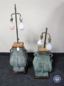 A pair of bronzed oriental style rise and fall table lamps (one stand missing a foot)