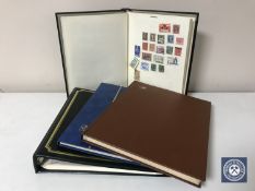 Three stamp albums and a folder containing late 19th century and later stamps - The World and Great