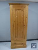 A pine sentry door wardrobe fitted a drawer