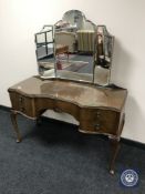 A walnut dressing table with triple mirror CONDITION REPORT: This measures 121cm