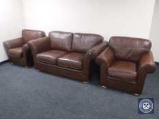 A brown leather three piece suite retailed by John Lewis