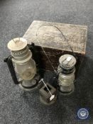 A wooden box together with three paraffin lamps