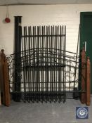 A 6' wrought iron and pine bed frame