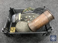 A basket containing trench art shell, military caps, WWI German water bottle,