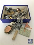 A box of assorted jewellery, vintage brooches, bottle lid,