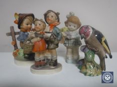 Two Hummel figures together with a Beswick Goldfinch and a figure of Mable Lucie Attwell..