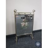 An Edwardian mirrored brass fire screen