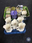 A box and basket containing six Rington's Maling lustre jugs, assorted tins,