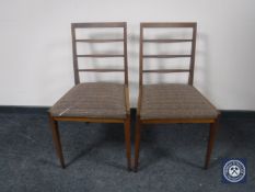 A pair of teak dining chairs