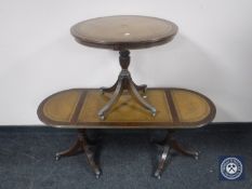 A mahogany pedestal occasional table with a tooled leather panel and oval coffee table