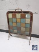 An early 20th century metal framed leaded glass fire screen