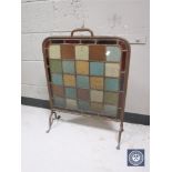 An early 20th century metal framed leaded glass fire screen