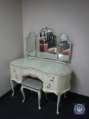 A cream and gilt kidney shaped dressing table with mirror with stool