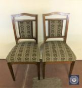 A pair of antique mahogany dining chairs