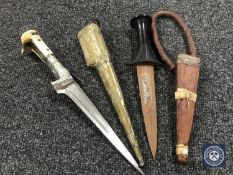 An African dagger in leather sheath and a Turkish dagger in brass sheath