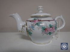 An antique hand painted Meissen style teapot with blue crossed swords to base and numbered in puce
