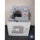 A boxed Singer heavy duty 4411 electric sewing machine