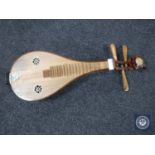 A Chinese four-stringed musical instrument CONDITION REPORT: The instrument is