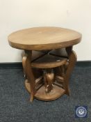 A circular occasional table fitted elephant table beneath and two further tables on elephant