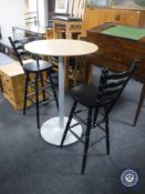 A pine topped metal based poser bar table and two bar chairs