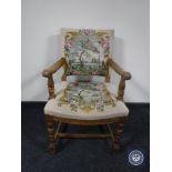 A 20th century oak armchair in floral tapestry fabric