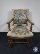 A 20th century oak armchair in floral tapestry fabric