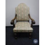 A 20th century carved oak scroll arm armchair in Regency stripe fabric