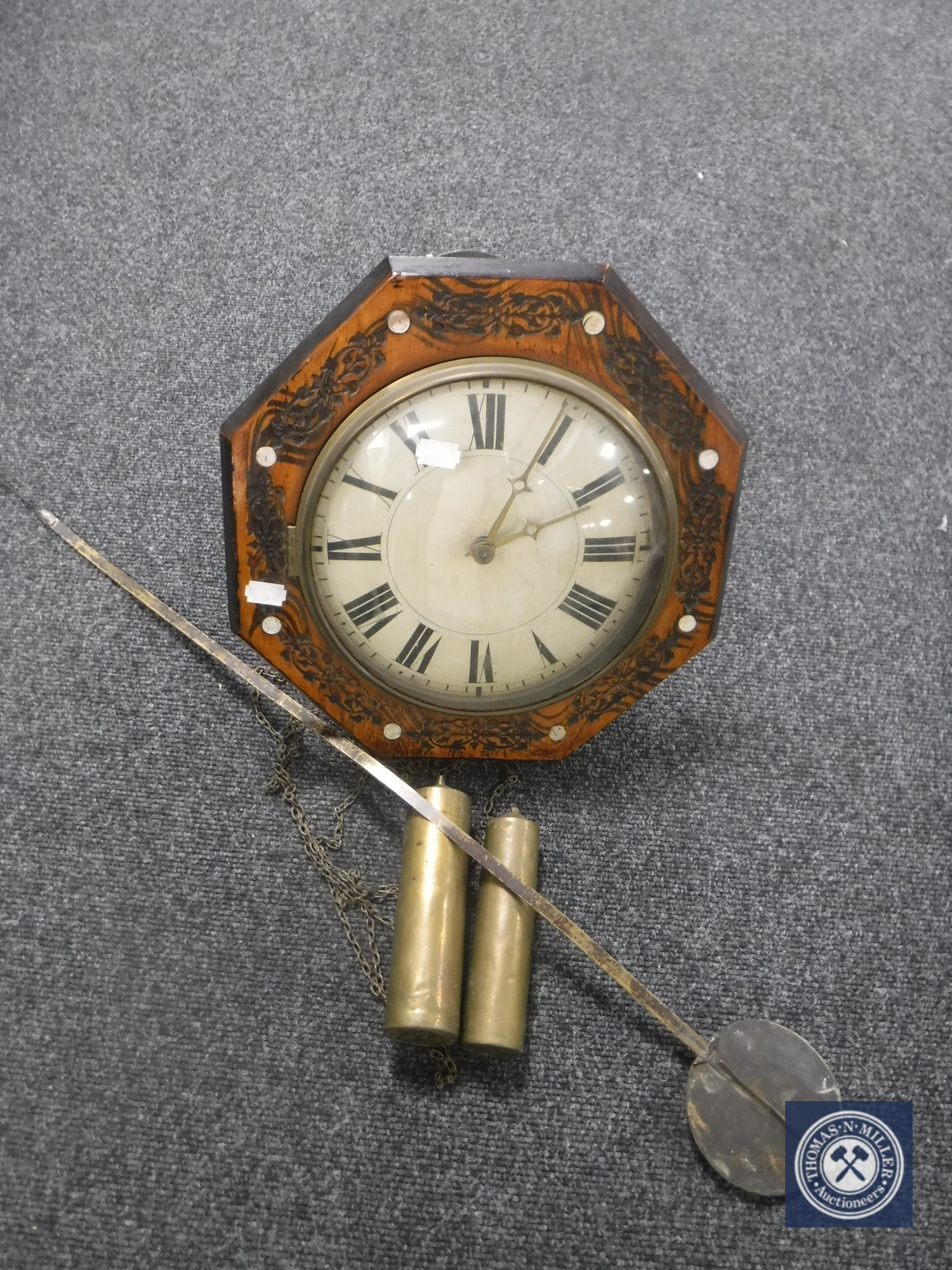 An antique timepiece with mother of pearl inlaid case together with two weights and pendulum