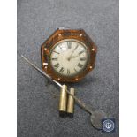 An antique timepiece with mother of pearl inlaid case together with two weights and pendulum