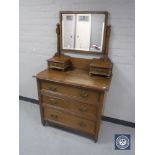 An Edwardian oak dressing chest