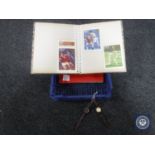 A crate containing two albums of first day covers together with two wristwatches
