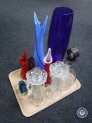 A tray of glass decanter together with two glass candle holders and six coloured glass vases