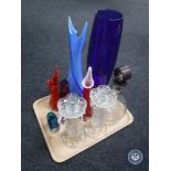 A tray of glass decanter together with two glass candle holders and six coloured glass vases