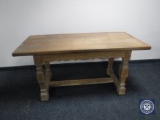 A continental oak refectory dining table fitted a drawer