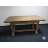 A continental oak refectory dining table fitted a drawer